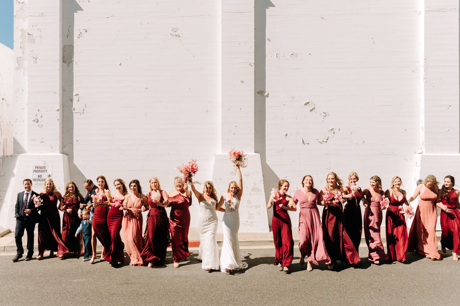 pink and red wedding party dresses, wedding party photos at Casino San Clemente